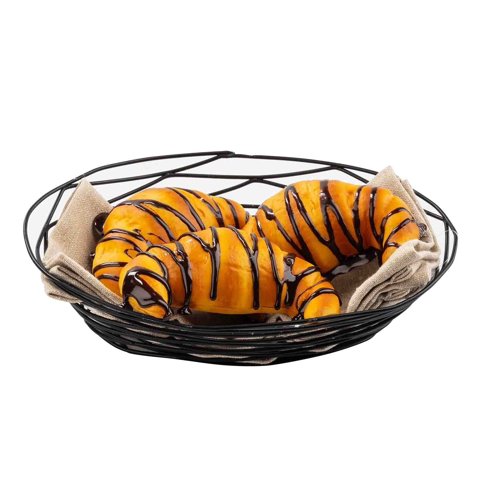 TableCraft BK17409 oval black wire basket filled with chocolate-drizzled croissants and a linen liner